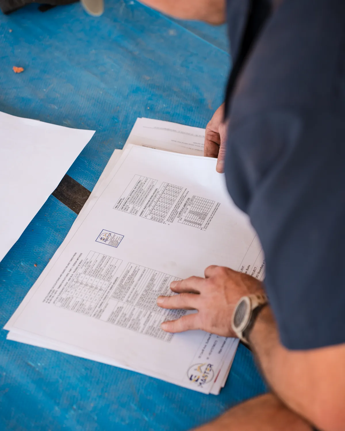 Reviewing structural plans and framing schedules on site — HV Built